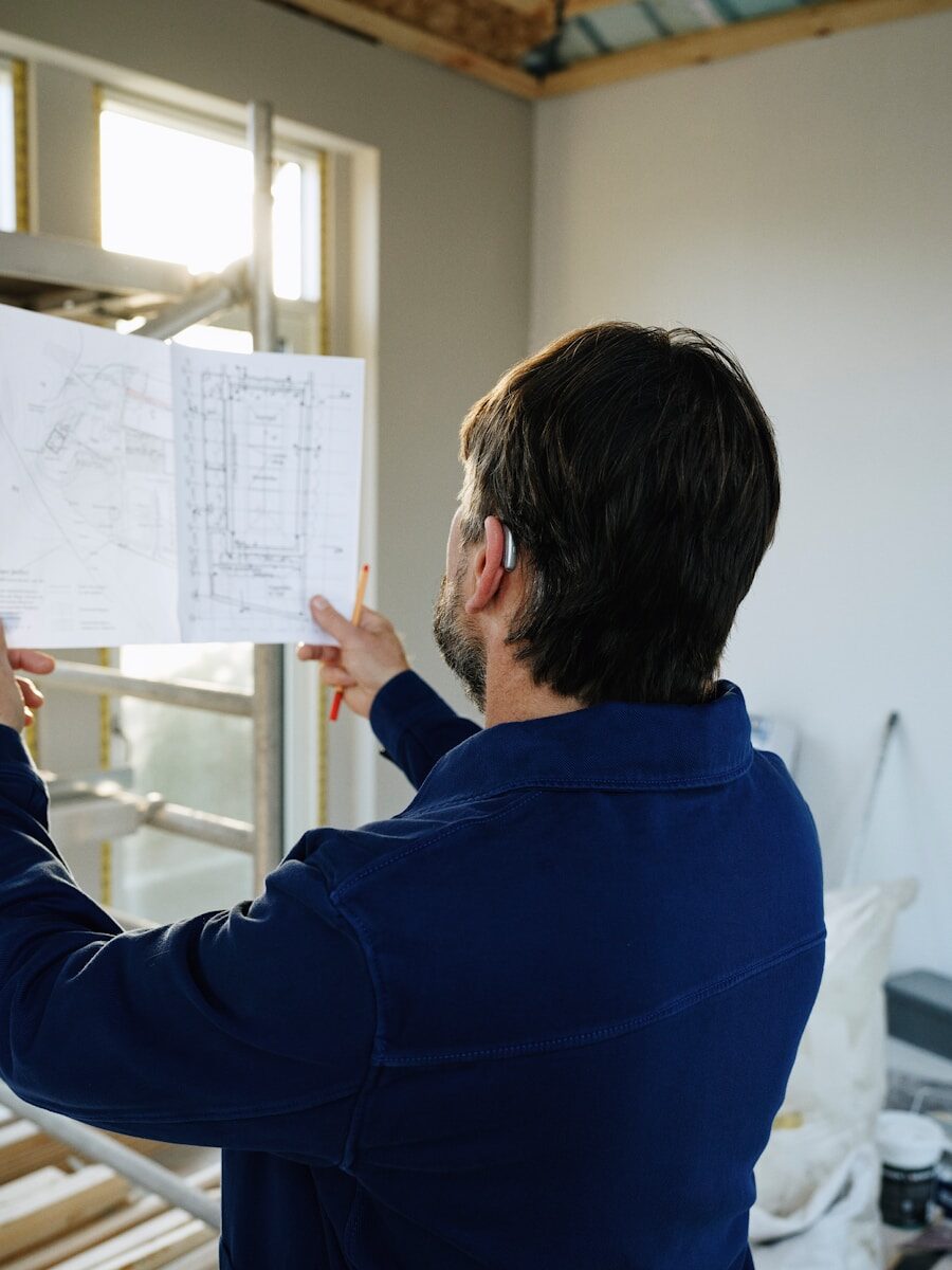 Man reviews blueprints at construction site